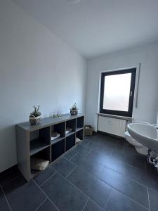 BonerathFerienwohnung Eira的一间带水槽和卫生间的浴室以及窗户。