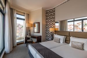 里斯本世界酒店的酒店客房设有一张床、一张书桌和窗户。