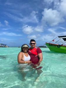 NusatupoCabañas sobre el mar en San Blas Narasgandub.的坐在海洋水中的男人和女人