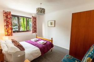 肯德尔UNDERWOOD COTTAGE - Peaceful House in Kendal with views of Cumbria的一间卧室设有一张床和一个窗口