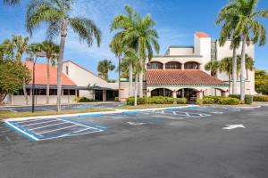 西棕榈滩88 Palms Hotel & Event Center的棕榈树建筑前的停车场