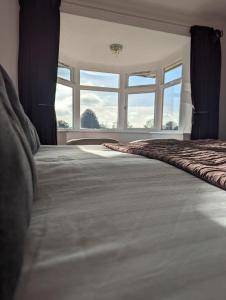 韦姆The Moorhead Bed & Breakfast的一间卧室设有一张大床和大窗户