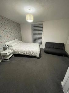 贝里212a bell lane的一间卧室配有一张床和一张沙发