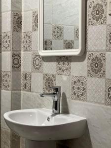 奥朱贝尔شقة سكنية بغرفتين نوم的浴室设有白色水槽和镜子