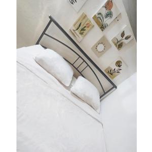 卡佩斯特雷贝勒奥Chambre Créole的一张带白色床单和枕头的床