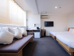 鹿儿岛You Style Hotel MARINE的一间酒店客房,设有两张床和电视