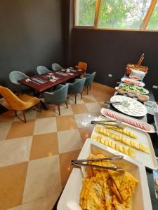 斯科普里Hotel Fama的一间用餐室,配有一张带食物盘的桌子