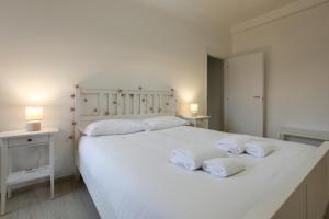 科尔西科Splendido Bilocale sul Naviglio Grande的卧室配有白色床和毛巾