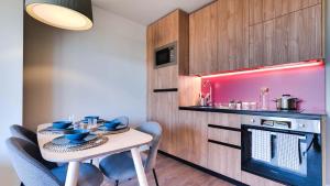 阿尔考本达斯Livensa Living Studios Madrid Alcobendas的小厨房配有桌椅和炉灶。