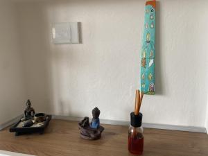 德尔维奥Appartamento Yuki的壁边的木地板上带雕像的花瓶