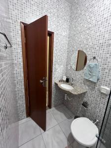 瓦拉达里斯州长市Andres' Home Vila Bretas的一间带卫生间、水槽和镜子的浴室