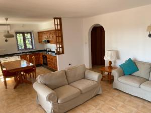 普拉亚布兰卡Las Brisas, Villa 98的一间带两张沙发的客厅和一间厨房