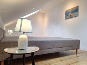 普克斯多夫Apartment Purkersdorf bei Wien Top 4的一间卧室配有一张床和一张带台灯的桌子
