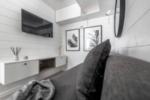 哥德堡Discover Gothenburg from equpped Studio的客房设有一张带电视和沙发的床。