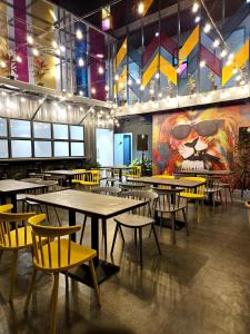 浦那Coliwo Trois - Kharadi的一间带桌椅和大型壁画的餐厅