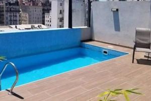 布宜诺斯艾利斯Amplio monoambiente con piscina的建筑物屋顶上的游泳池