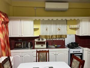 DunfermlineEstuary Apartment 2的厨房配有白色橱柜和炉灶。
