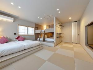 中津川市岩寿莊日式旅馆的一间带两张双层床的卧室,铺有瓷砖地板。