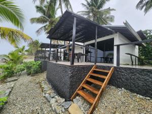 TigbaoSurigao Dream Beach Resort的前面有楼梯的房子