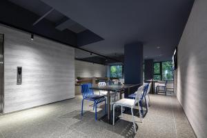 杭州杭州西湖湖滨浣纱路轻居酒店的一间配备有蓝色椅子和桌子的用餐室