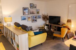 PublierL'Escale du Léman的客厅配有黄色沙发和电视