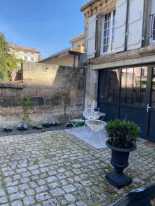 昂古莱姆Maison + parking privé au Cœur Angoulême 60m2的庭院,带蓝色门的建筑