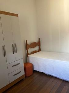 维索萨Quartos em casa no Clelia Bernardes的一间小卧室,配有一张床和一个梳妆台