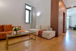 雅典Athenaeum Eridanus Luxury Hotel的客厅配有沙发和桌子
