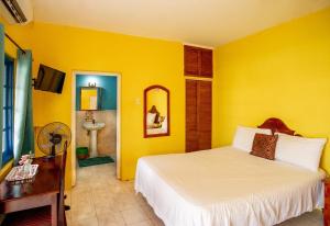 布莱克河Waterloo Guest House的一间卧室设有一张床和黄色的墙壁
