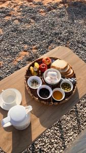 BadīyahMarbella bungalows desert的木桌上的一盘食物,上面有一盘食物