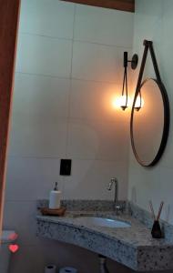 波梅罗迪Pousada Hoff Haus的浴室配有水槽和墙上的灯。