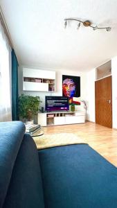 林茨Apartment 14 im Herzen von Linz的客厅配有蓝色的沙发和电视