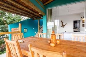 伊利亚贝拉Casa Bambolê em Ilhabela的一间带木桌和椅子的用餐室