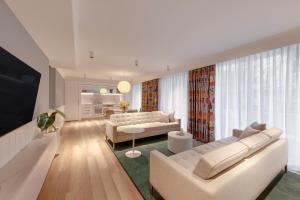 悉尼齐本德尔阿迪娜公寓酒店的客厅配有白色家具和大窗户