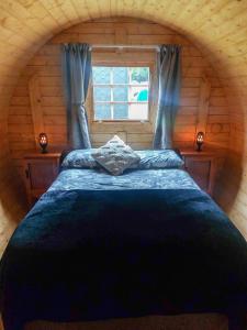 OxfordAshley Gorge Holiday Park的小木屋内一间卧室,配有一张大床