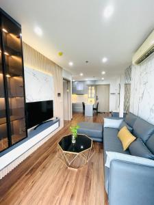 Thôn Văn DươngAmy Apartment in Nera Garden Hue的客厅配有蓝色的沙发和平面电视。