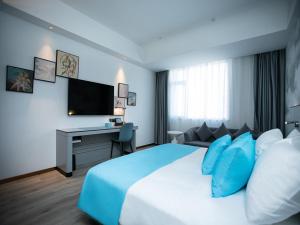 涟水淮安涟水高铁站炎黄大道兰欧酒店的酒店客房设有一张大床和一张书桌。
