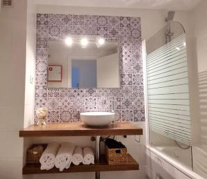 加的斯www Casa Quili Cádiz com的浴室配有盥洗盆、镜子和毛巾