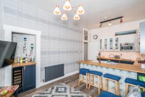 爱丁堡Pass the Keys Trendy Historic flat sleeps 4 to 6 near Leith Shore的厨房设有蓝椅酒吧