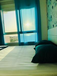 丹吉尔NOUVEAU, Residence Cap Spartel avec une vue sur mer的一间卧室设有一张大床和窗户