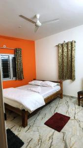奇克马格尔Evergreen Shola View的橙色墙壁的客房内的两张床