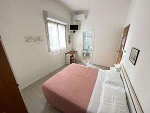 米兰马瑞提那Hotel Fiorenza的一间卧室设有一张大床和一个窗户。