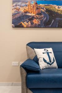 梅利哈Aloha - Village Apartment 2 BR in Mellieha的客房内的带枕头的蓝色椅子