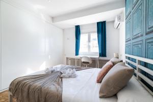 格拉纳达Neptuno Ático, con terraza的一间卧室配有一张带蓝色窗帘的大床