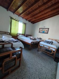 瓜塔佩Hotel Casa Verde Guatapé的一间房间,有三张床
