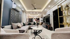 伊斯兰堡LMY Elysium Designer Luxury Apartments Facing Centaurs Mall Islamabad的客厅配有沙发和桌子