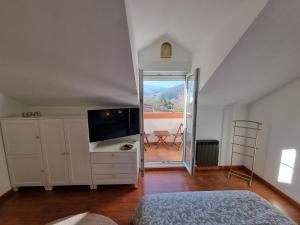 VillabáñezRomántico apartamento con terraza y piscina的一间卧室配有一张床和一台电视。