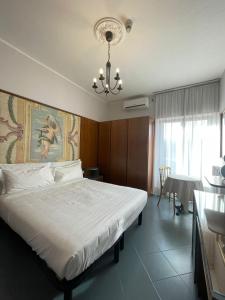 Cittiglio拉布索拉酒店的一间卧室配有一张大床和一个吊灯。