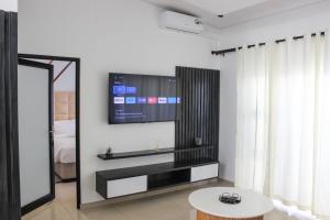 温特和克Deluxe Residence - Windhoek的客厅的墙上配有电视