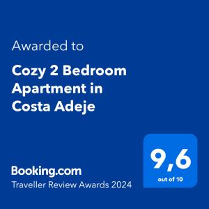 阿德耶Cozy 2 Bedroom Apartment in Costa Adeje的手机的屏幕,带有文字升级到舒适的卧室公寓